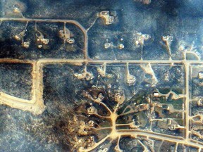 A satellite image shows destroyed houses in a neighbourhood along Sommer Way (centre) in Fort McMurray, Alta. on May 6, 2016. Smoke from the fires prompted Environment Canada to issue air quality advisories for northeastern Alberta and northwestern Saskatchewan. THE CANADIAN PRESS/EARTH-i/21AT MANDATORY CREDIT ORG XMIT: CPT102