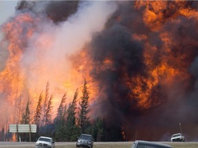 A giant fireball is seen as a wildfire rips through the forest 16 kilometres south of Fort McMurray,  on Highway 63 Saturday, May 7, 2016.