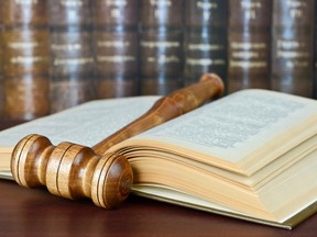 Local Input~ Wood gavel and old yellowed book on the background of shelves of old books. Credit: fotolia.