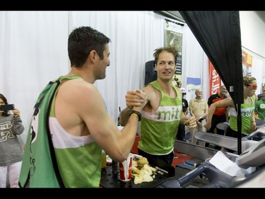 Dave Proctor gets some encouragement while setting a world record on a treadmill during the Calgary Marathon Expo at the Big Four Building in Calgary, Alta., on Saturday, May 28, 2016. Seven world records for treadmill running were broken, including Dave Proctor's 24-hour run, all in support of MitoCanada. Lyle Aspinall/Postmedia Network