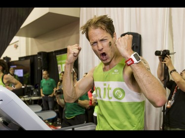 Dave Proctor celebrates setting a world record on a treadmill during the Calgary Marathon Expo at the Big Four Building in Calgary, Alta., on Saturday, May 28, 2016. Seven world records for treadmill running were broken, including Dave Proctor's 24-hour run, all in support of MitoCanada. Lyle Aspinall/Postmedia Network