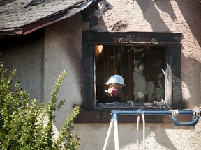 FILE PHOTO: Police investigators at the scene of a fire in Falconridge where five people died in Calgary, on Saturday May 7, 2016.