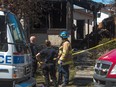 Police investigators at the scene of a fire in Falconridge where five people died in Calgary on Saturday May 7, 2016.