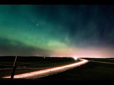 Vehicles leave light streaks on Highway 1 as the aurora borealis lights up the night west of Calgary, Ab., on Sunday May 8, 2016. Mike Drew/Postmedia