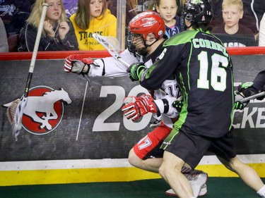 Calgary Roughnecks Curtis Dickson checked by Saskatchewan Rush Chris Corbeil in NLL action at the Scotiabank Saddledome in Calgary, Alta. on Saturday May 14, 2016. Mike Drew/Postmedia