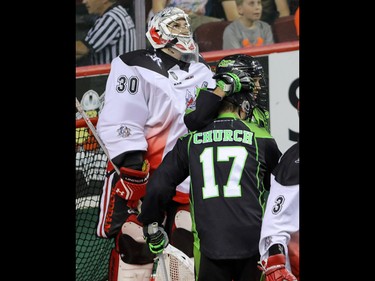 Calgary Roughnecks goalie Mike Poulin reacts as  Saskatchewan Rush Jarrett Davis and Robert Church celebrate a goal in NLL action at the Scotiabank Saddledome in Calgary, Alta. on Saturday May 14, 2016. Mike Drew/Postmedia