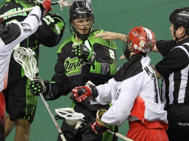 Saskatchewan Rush Brett Mydske and Calgary Roughnecks Mike Carnegie disagree in NLL action at the Scotiabank Saddledome in Calgary, Alta. on Saturday, May 14, 2016. The Rush beat the Roughnecks 16-10. Mike Drew/Postmedia