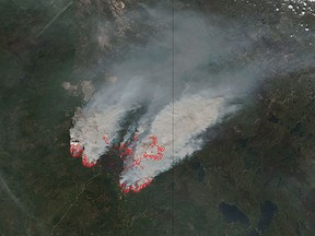 In this NASA satellite image obtained May 17, 2016, smoke from wildfires burning near Fort Mcmurray, Canada can be seen. (0200 GMT Tuesday) for a region between Fort McMurray and a few kilometers south of the town of Fort MacKay, officials said.  /