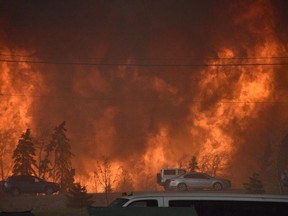 A wall of fire rages outside of Fort McMurray on Tuesday May 3, 2016.