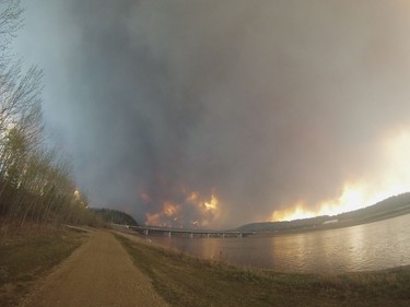 A wildfire rages west of Fort McMurray Tuesday afternoon as viewed from the side of the Athabasca River