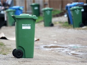 Green box composting boxes are lined up for pick-up with black garbage and blue recycling boxes in Abbeydale on Thursday May 15, 2014. Abbeydale is one of the Calgary neighbourhoods that is part of the composting box pilot project.