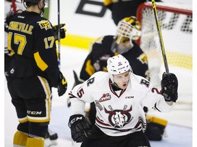 Brandon Wheat Kings' John Quenneville, left, and goalie Jordan Papirny look on as Red Deer Rebels' Adam Musil, centre, celebrates his tying goal during third period CHL Memorial Cup hockey action in Red Deer, Wednesday, May 25, 2016.THE CANADIAN PRESS/Jeff McIntosh ORG XMIT: JMC121