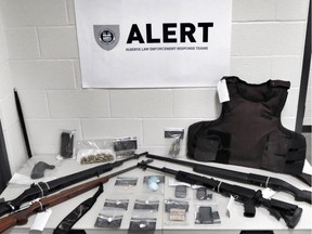 ALERT's Red Deer organized crime and gang team made the seizure on May 19 with the assistance of RCMP Red Deer. A home in the 4900-block of 54 Street was searched and the following items were seized: SKS semi-automatic carbine with collapsible stock; .308-caliber semi-automatic rifle; 7mm rifle; 12 gauge shotgun; various ammunition; body armour; 9 grams of cocaine; 98 suspected codeine pills; $980 cash proceeds of crime. Supplied photo