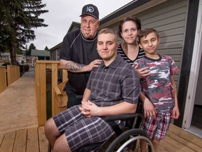 Alex,  with mom Stella, brother Lucas and dad John, a teen paralyzed in tobogganing accident, will participate in the Calgary Marathon to raise awareness for spinal cord injuries in Calgary, Ab., on Saturday May 21, 2016. Mike Drew/Postmedia