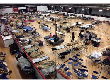 Cots litter the gym floor at an evacuee reception centre set up and operated by the regional municipality of Wood Buffalo in Anzac, Alta., on Wednesday, May 4, 2016. Raging forest fires whipped up by shifting winds sliced through the middle of the remote oilsands hub city of Fort McMurray Tuesday, sending tens of thousands fleeing in both directions and prompting the evacuation of the entire city.