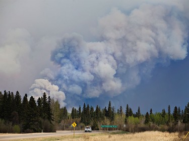 A police vehicle drives towards a wildfire in Fort McMurray on Thursday, May 5, 2016.