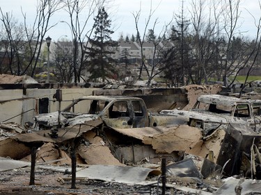 Burned out trucks are shown in the Beacon Hill neighbourhood during a media tour of the fire-damaged city of Fort McMurray, Alta. on Monday, May 9, 2016.