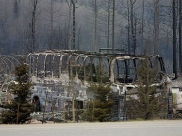 A burned out shell of a bus is shown on the side of the highway on a media tour of the fire-damaged city of Fort McMurray, Alta. on Monday, May 9, 2016.