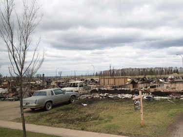 A for sale sign sits in front of a house destroyed in the wildfires is seen in the Beacon Hill neighbourhood in Fort McMurray, Alta., on Monday, May 9, 2016.