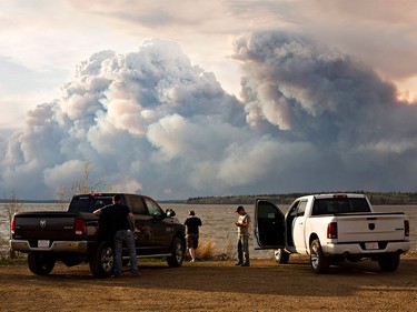 Evacuees watch the wildfire near Fort McMurray, Alberta, on Wednesday, May 4, 2016. Alberta declared a state of emergency Wednesday as crews frantically held back wind-whipped wildfires.  No injuries or fatalities have been reported.