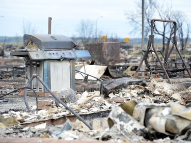 A burned out barbecue and swing are shown in the Beacon Hill neighbourhood during a media tour of the fire-damaged city of Fort McMurray, Alta. on Monday, May 9, 2016.