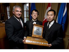 Calgary Herald editor Jose Rodriguez presents the Calgary Herald Trophy to Bryan Ma and Richard Li of Western Canada High School during the Sir Winston Churchill Society of Calgary's 50th anniversary gala at the Ranchmen's Club in downtown Calgary, Alta., on Wednesday, May 11, 2016. Ma and Li earned the triphy by winning the Senior Open Category in the society's debate event in November. Lyle Aspinall/Postmedia Network