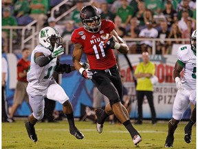 BOCA RATON, FL - DECEMBER 23: Juwan Brescacin #11 of the Northern Illinois Huskies rushes for a touchdown during the first half of the game against the Marshall Thundering Herd at FAU Stadium on December 23, 2014 in Boca Raton, Florida.  Rob Foldy/Getty Images/AFP