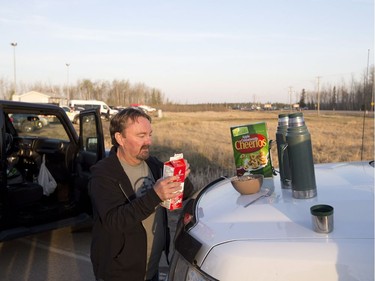 Byron Cross has a make shift breakfast on his truck at a rest stop, after being evacuated from Fort McMurray, on Wednesday, May 4, 2016.