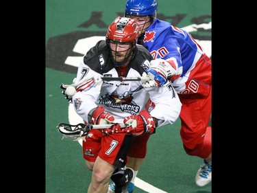 The Calgary Roughnecks' Tyler Burton and the Toronto Rock's Kri Bradley fight for control of the ball during National Lacrosse league action at the Scotiabank Saddledome on Saturday, April 30, 2016.