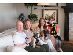 Chris, Jenn, Alyssa and Gage Ferguson with their dogs Smudge and Bugatti. They bought a home by Jayman Built in Riviera.
