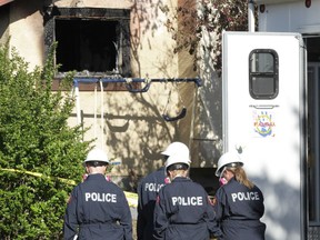 Calgary Poilice and firefighters investigate a fire on Falchurch Cr NE in Calgary, Alta on Saturday May 7, 2016. Five people, all believed to be adults died at the scene. Jim WellsPostmedia