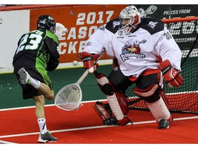 Calgary Roughnecks goalie Mike Poulin blocks a shot by Saskatchewan Rush Jarrett Davis in NLL action at the Scotiabank Saddledome in Calgary, Alta. on Saturday May 14, 2016. Mike Drew/Postmedia