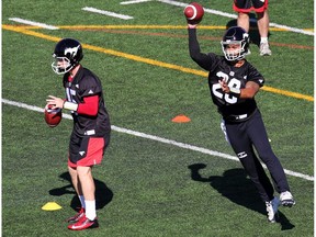 Quarterbacks Andrew Buckley, left and Bryant Moniz drill on the opening day of the Calgary Stampeders training camp at McMahon Stadium on Sunday May 29, 2016. Gavin Young/Postmedia