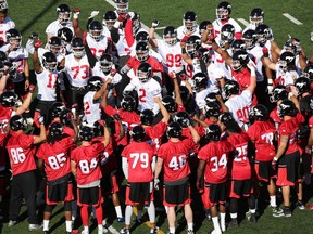 Players group rally together at the start of the first practice of the Calgary Stampeders training camp at McMahon Stadium on Sunday May 29, 2016. Gavin Young/Postmedia