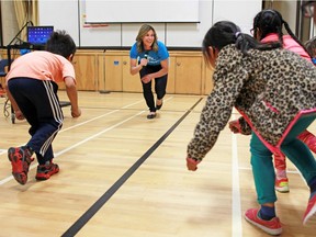 Olympic gold medallist Catriona Le May Doan demonstrates the strength needed for speedskating during a presentation on having fun in sport at St. Henry School on May 11, 2016.