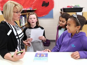 University School principal Kathy Salmon chats with from left; Sarah McCormack, Ankita Chaturvedi and Melanie Carabali in the school library on Thursday, May 12, 2016. Ankita and Melanie are among almost 100 Fort McMurray student evacuees now in class at the northwest Calgary school and Sarah is also from Fort McMurray and her grandparents were in the town when the wildfire hit.