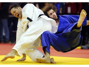 Mathieu Lemay of Ontario, left, throws Samuel Kristoffersen of New Brunswick to the mat during his win in the veterans under 40 category at the Canadian Open Judo Championships Friday May 13, 2016 at the Olympic Oval.