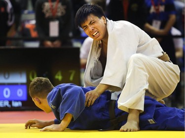 Ian Ryder of BC is pushed to the mat by Thomas Tran of Quebec during their under 18 90 kilogram match at the Canadian Open Judo Championships Friday May 13, 2016 at the Olympic Oval.