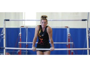 Brittany Rogers takes a break from training on the uneven bars at the Calgary Gymnastics Centre in preparation for her hopeful return to the Olympic stage in Artistic Gymnastics Wednesday May 118, 2016. She competed in the 2012 games in London and is hoping to make the Canadian team going to Rio de Janeiro. (Ted Rhodes/Postmedia)