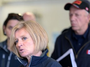 Premier Rachel Notley speaks at the Fort McMurray fire department as fire chief Darby Allen looks on in Fort McMurray, Monday, May 9, 2016.