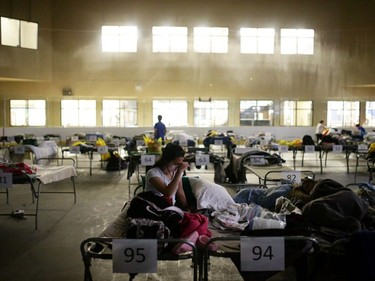 Tyra Abo sits on a cot at a makeshift evacuee center in Lac la Biche, Alberta on May 5.