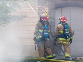 Firefighters deal with a house fire on Chapalina Grove SE in Calgary on Wednesday, May 4, 2016. There was no early word on injuriesor the cause of the blaze, but speculation was pointing to a discarded cigarette.