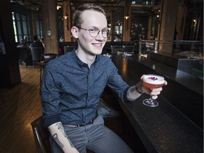 Charbar bar manager Justin Foltinek holds his Parlour Gin creation, the Nona cocktail. (Kerianne Sproule/Postmedia) (For You section story by Lisa Kadane)