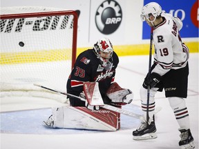 Red Deer Rebels' Jake Debrusk, right, scores on Rouyn-Noranda Huskies goalie Chase Marchand during second period CHL Memorial Cup hockey action in Red Deer on May 22, 2016.