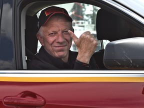 Fort McMurray Fire Chief Darby Allen gives a thumbs up after giving an operational update and to announce he will no longer be in charge of the fire, to media at an RCMP checkpoint about 8 km south of Fort McMurray, May 12, 2016.