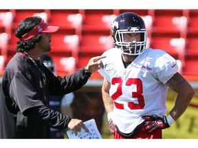 Colleen De Neve/ Calgary Herald CALGARY, AB -- AUGUST 19, 2015 -- Calgary Stampeders running back William Langlais (number 23), got some instruction from special teams coordinator Mark Kilam during practice at McMahon Stadium on August 19, 2015. The Stampeders take on the 0-7 Roughriders this weekend. (Colleen De Neve/Calgary Herald) (For  story by Rita Mingo) 00067799A SLUG: 0820-Stamps Practice