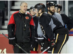 Colleen De Neve/ Calgary Herald CALGARY, AB --DECEMBER 30, 2015 -- Calgary Flames head coach Bob Hartley gave defenceman Dougie Hamilton some instructions as he ran the team through drills during practice at the Scotiabank Saddledome on December 30, 2015. (Colleen De Neve/Calgary Herald) (For Sports story by Scott Cruickshank) 00071063A SLUG: FLAMES