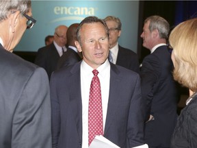 Doug Suttles, president and CEO of Encana Corp., talks with shareholders after the company's annual meeting in Calgary.