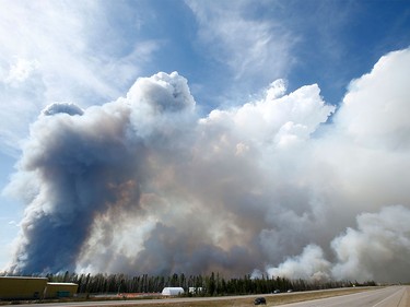 A massive wildfire is seen from Highway 63 near Fort McMurray, Alta., on Wednesday May 4, 2016. A massive evacuation of Fort McMurray was held after a large wildfire struck the city.