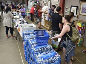 Volunteers sort through donations at Edmonton Emergency Relief Services which is co-ordinating efforts for the Fort McMurray evacuees.